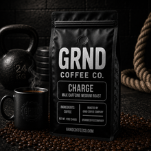 GRND Coffee CHARGE max caffeine medium roast bag with steaming black mug in a gym