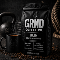 GRND FOCUS medium roast coffee bag with steaming mug in a training gym